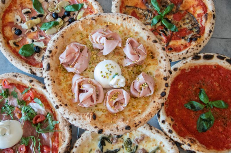 Prosciutto and arugula gourmet thin crust pizza